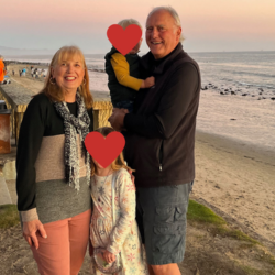 Holding our grandkids on the edge of the beach