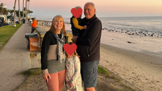 Holding our grandkids on the edge of the beach